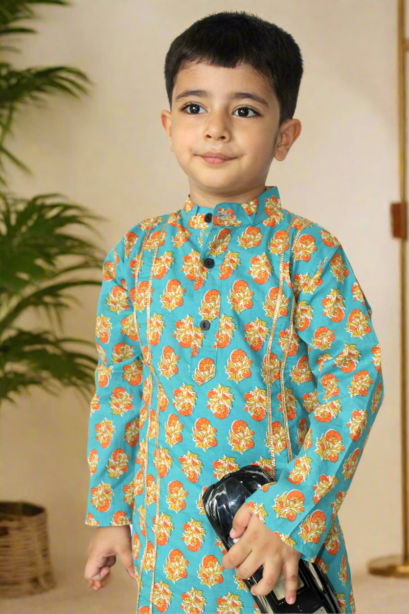 Child wearing a blue floral traditional outfit on a white background