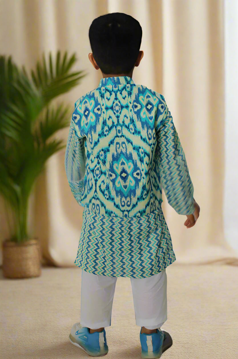 Child wearing a blue and green ikat print kurta jacket with white pants against a white background