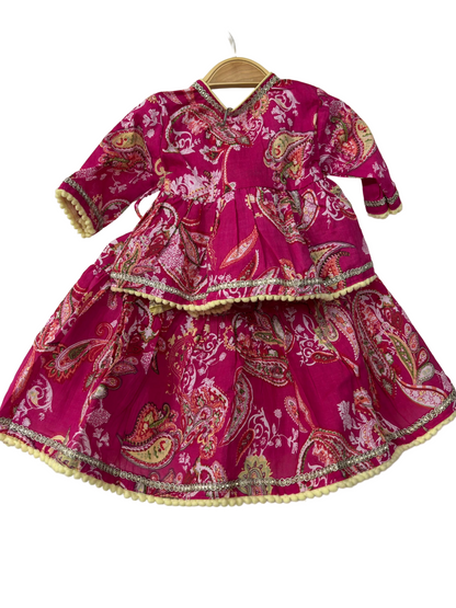 Pink traditional outfit with paisley patterns
