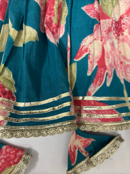 Floral patterned fabric with gold trim on a blue